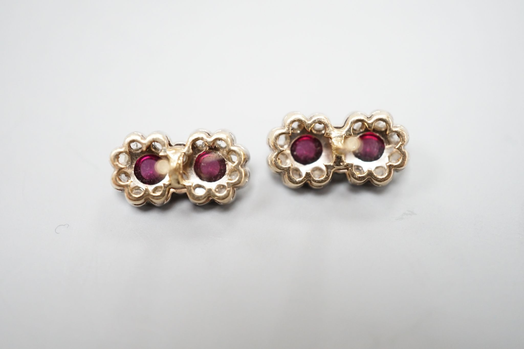 A pair of cabochon garnet and diamond set double cluster earrings (lacking butterflies), 14mm, gross weight 2.5 grams.